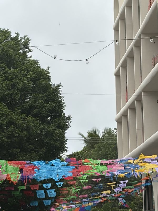 Rows of bright papel picado banners strung across a street