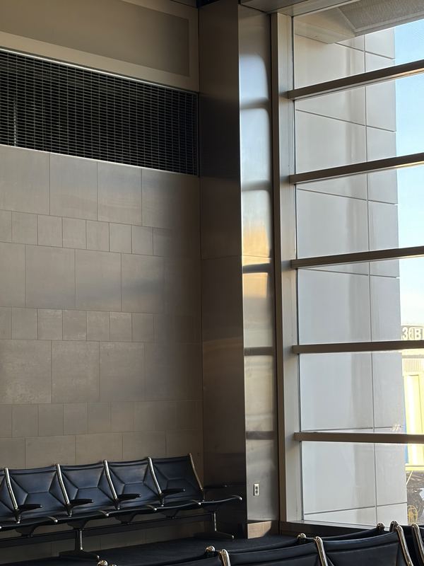 Late sun falling across an empty airport gate